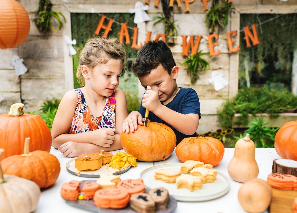 Young Kids Carving Halloween Jack-o'-lanterns 