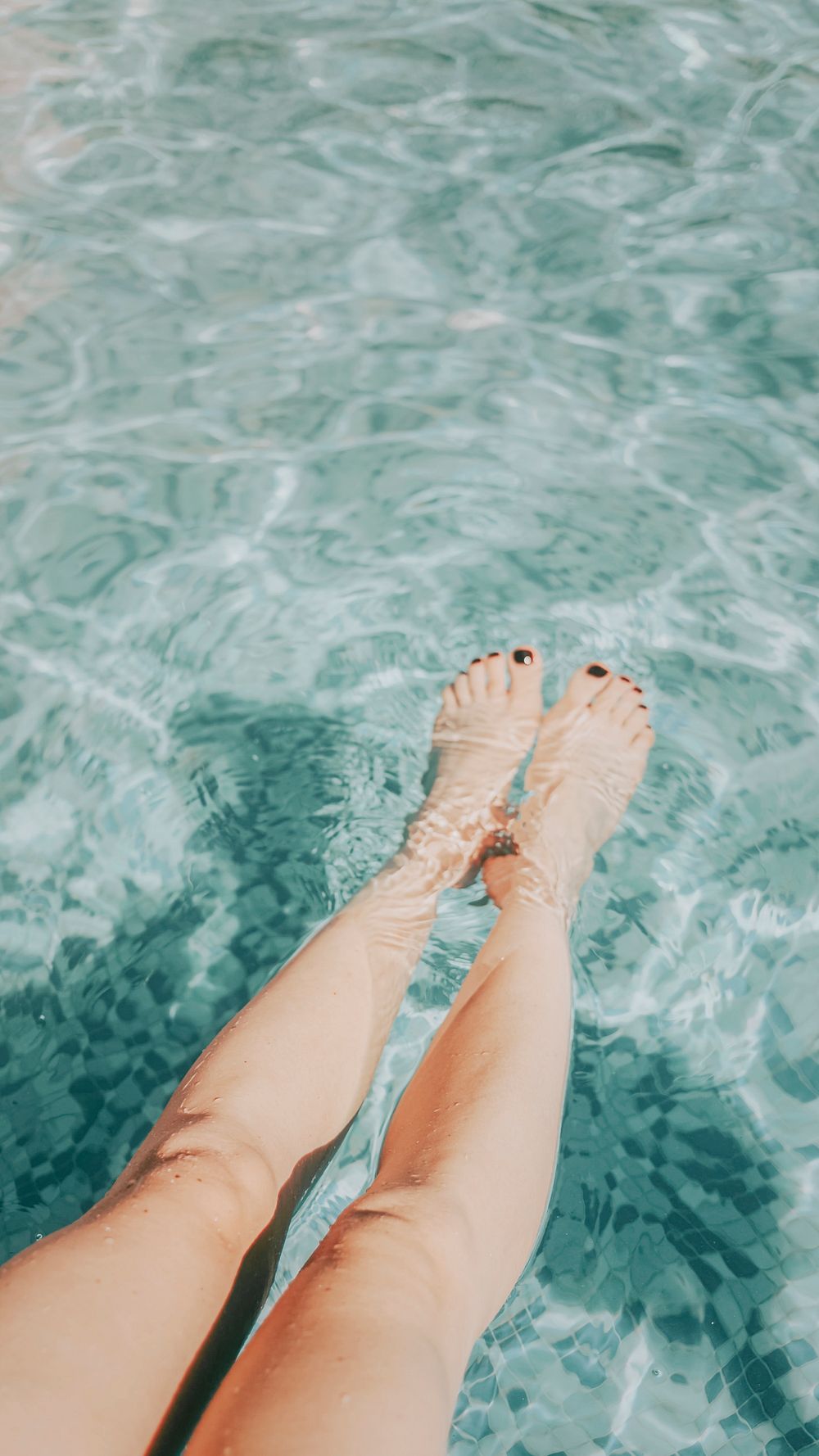 Woman putting her legs in the pool | Premium Photo - rawpixel
