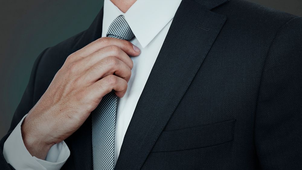 Businessman Adjusting His Tie 