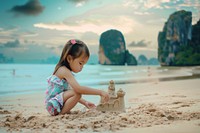 East asian little girl beach sand sea.