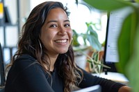 Enthusiastic Hispanic Woman looking on Computer happy woman photo.