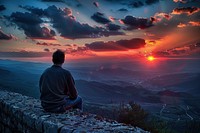 Back view of man sitting on a wall sunset photo photography.