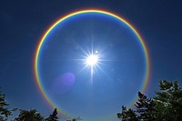 Rainbow ring around sun rainbow astronomy outdoors.