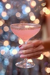 A pink cocktail glass medication beverage.