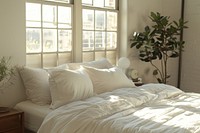 White 4 pillows on bed furniture cushion indoors.