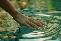 Hand touching water surface female outdoors person.