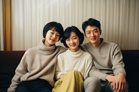 Joyful korean Family on minimal modern Couch family clothing knitwear.