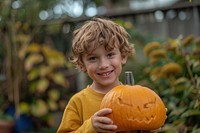 Kid holding a jack Pumpkin jack-o-lantern halloween festival.