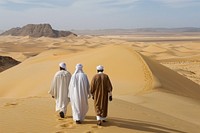Three wise man in desert clothing footwear standing.