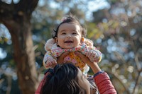Nepalese mother lifting her adorable baby photo photography portrait.