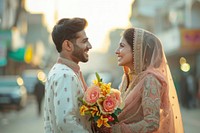 Pakistani couple giving flower bridegroom wedding person.