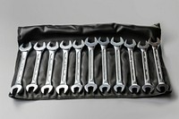 Set of metric combination wrenches neatly organized weaponry blade razor.