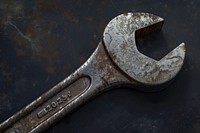 Well-worn adjustable wrench with chipped paint tool corrosion weaponry.