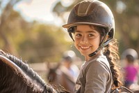 Hispanic girl kid helmet happy horse.