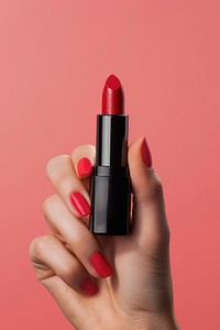 Vertical photo shot of a hand holding a gloss color lipstick medication cosmetics pill.