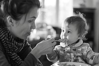 Mom feeding food baby with spoon photo photography portrait.