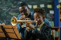 Teacher teaching black boy play trumpet at music classroom accessories flugelhorn recreation.
