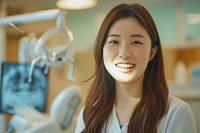 A asian woman dentist smile aganist dental person female happy.
