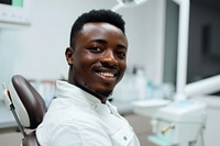 Black man smile sitting on dentist chair furniture person adult.