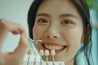Dentist hold teeth palette near woman smiling festival cutlery person.