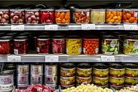 A display of canned food in the grocery store shelf tin aluminium.