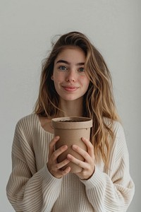 Girl holding a craft pot package with label photography portrait person.