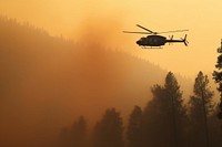 A helicopter carrying water to extinguish forest fires transportation aircraft outdoors.