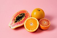 A papaya cut in half grapefruit orange produce.