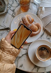 A Phone held taking pictures coffee phone plate.