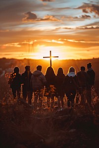 Group of People Holding Cross and Praying people cross backlighting.