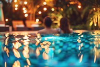Young couple traveler relaxing and enjoying a tropical resort pool recreation lighting swimming.