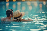 Young couple traveler relaxing and enjoying a tropical resort pool recreation swimming clothing.