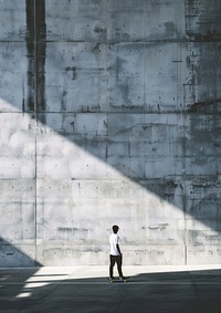 Man playing skateboard wall architecture construction.