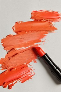 Lipsticks swatch in 3 gloss shades of orange on white paper cosmetics animal shark.