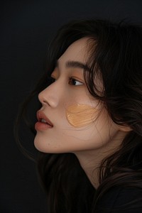 Liquid face foundation swatch on asian woman cheek makeup photo photography.