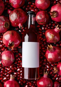 Bottle of pomegranate juice produce candle fruit.