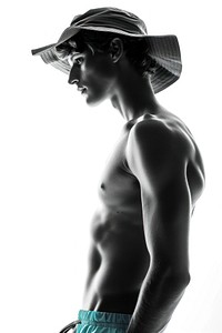 Young athletic swimmer wear hat and swimming trunks photography back portrait.