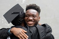 Black students and graduates hug happy clothing hugging.