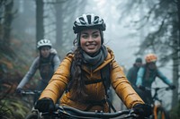 Smiling young woman in cycling gear riding bike transportation clothing.