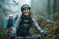Smiling young woman in cycling gear riding bike transportation vegetation.