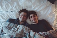 Two men in bed photo photography furniture.