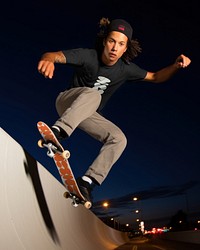 Man playing skateboard at night