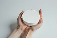 Hand hold white product round shaped box photography porcelain cosmetics.