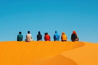 Six middle east friends sitting on top of the sand dunes sky outdoors horizon.