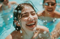 Asian woman laughing and swimming in the pool happy accessories recreation.
