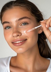 Woman applying facial serum drops cosmetics person female.