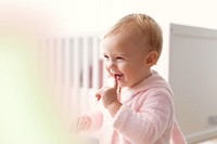 Cute baby girl smiling in her nursery