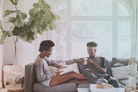 Black couple reading a book together on the couch