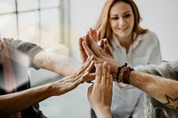 Group of diverse team joining hand in the middle