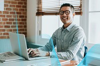 Asian businessman in an office using a laptop
